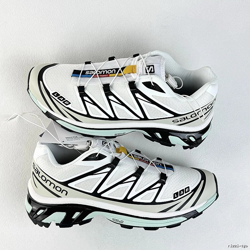 Salomon White and Black Trail Sneakers Highlighting Treaded Trail Sole